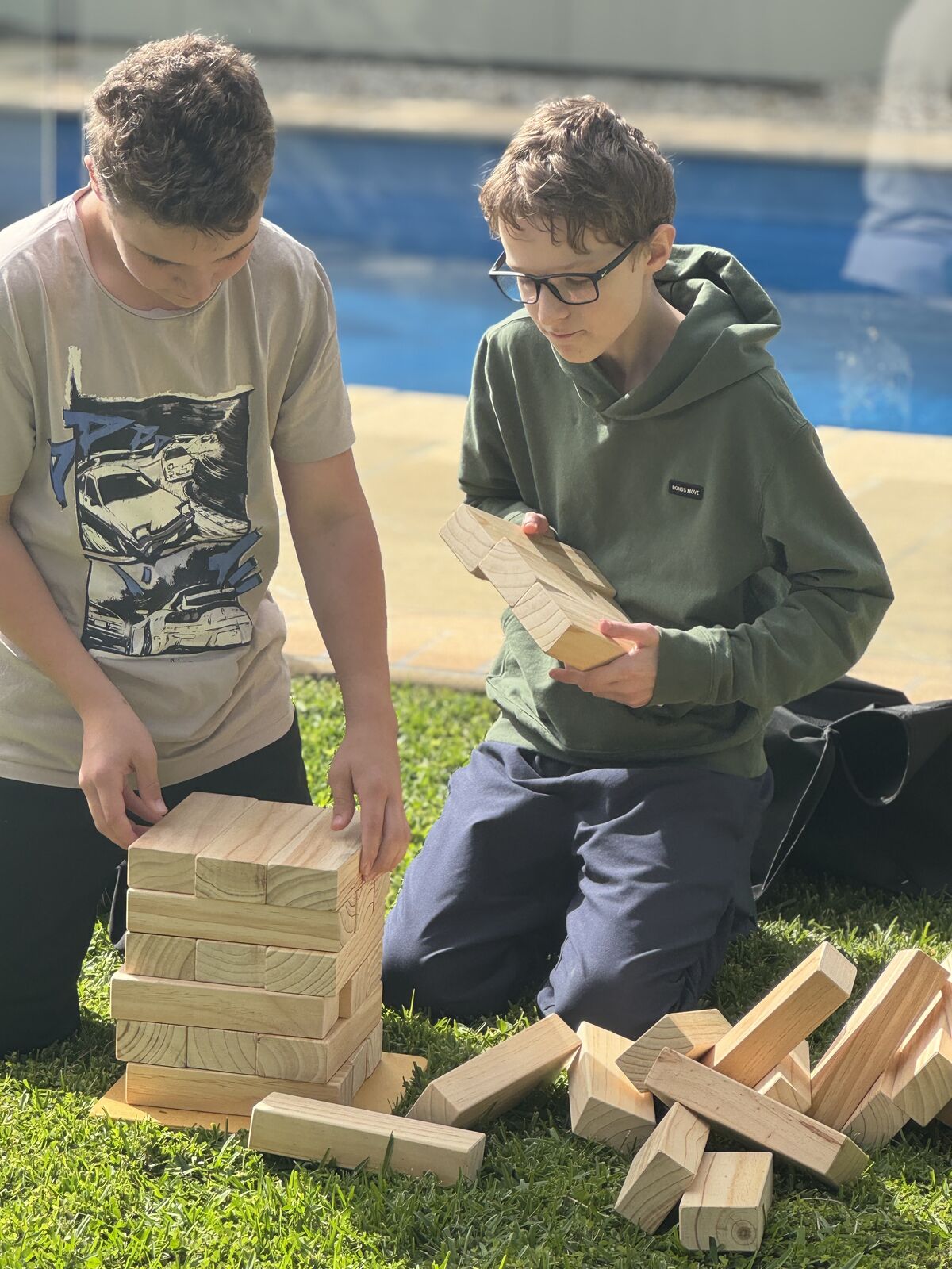 Kids playing giant Jenga outdoors